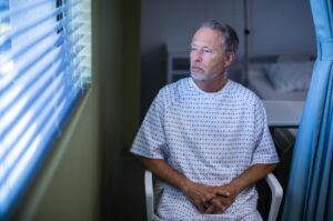 Patient in a hospital room preparing to undergo surgery as part of prostate cancer treatment.